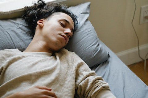 man taking nap resting recovery mental health sleep