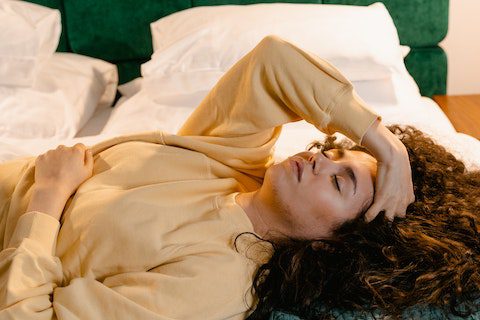 woman lying down can't sleep mental health