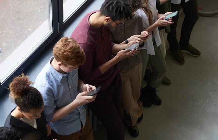 social media, group of people on phone social media addiction